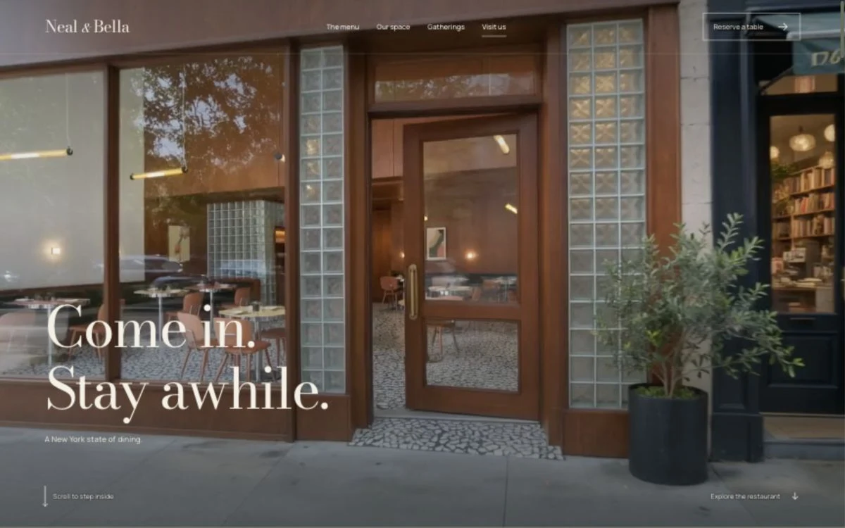 Neal & Bella restaurant website with warm wood interiors, mosaic floors and elegant ivory lettering